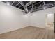 Unfinished basement with white walls, wood-look floors, black painted ceiling and stairs at 2729 Ridge Valley Nw Rd, Atlanta, GA 30327