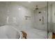 A modern bathroom with a soaking tub and a walk-in shower with gold fixtures at 2729 Ridge Valley Nw Rd, Atlanta, GA 30327
