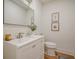 Clean and bright half bathroom featuring a modern vanity with sink, a sleek mirror, and neutral decor at 2729 Ridge Valley Nw Rd, Atlanta, GA 30327