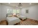 Bright bedroom with hardwood floors, a ceiling fan, and two twin beds at 2729 Ridge Valley Nw Rd, Atlanta, GA 30327