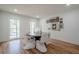 Bright dining room with unique white wicker chairs, a modern round table, and multiple windows at 2729 Ridge Valley Nw Rd, Atlanta, GA 30327