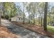 Charming home with a white painted brick exterior, surrounded by mature trees and an inviting driveway at 2729 Ridge Valley Nw Rd, Atlanta, GA 30327