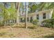 Classic white brick home with well-maintained landscaping and mature trees, offering a timeless appeal at 2729 Ridge Valley Nw Rd, Atlanta, GA 30327