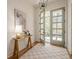 Stylish foyer showcasing hardwood floors, a patterned rug, and a trendy table with a decorative lamp at 2729 Ridge Valley Nw Rd, Atlanta, GA 30327