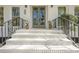 Elegant front entrance with white brick stairs, black iron railings, and a stylish glass-paneled door at 2729 Ridge Valley Nw Rd, Atlanta, GA 30327