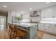 Modern kitchen with white cabinets, stainless steel appliances, and a kitchen island with bar stools at 2729 Ridge Valley Nw Rd, Atlanta, GA 30327