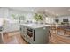 An open kitchen with an island, stainless steel oven, view into the breakfast nook and living room at 2729 Ridge Valley Nw Rd, Atlanta, GA 30327