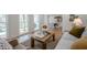 Cozy living room with many windows, hardwood floors, a patterned rug, and comfortable furniture at 2729 Ridge Valley Nw Rd, Atlanta, GA 30327