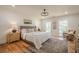 Calm main bedroom showcasing hardwood floors, neutral colors, large windows, and an elegant ceiling fan at 2729 Ridge Valley Nw Rd, Atlanta, GA 30327