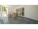 Covered porch with stone pavers, chairs, and sliding glass door leading inside at 2729 Ridge Valley Nw Rd, Atlanta, GA 30327