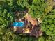 Aerial view of home with swimming pool surrounded by lush trees at 3307 Pointe Bleue Ct, Decatur, GA 30034