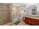 Bathroom featuring double sinks, and a shower-tub combo with glass door at 3307 Pointe Bleue Ct, Decatur, GA 30034