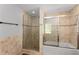 Well-lit bathroom featuring a shower-tub combo and neutral tile design at 3307 Pointe Bleue Ct, Decatur, GA 30034