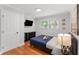 This bedroom features hardwood floors, natural light, and plenty of closet space at 3307 Pointe Bleue Ct, Decatur, GA 30034
