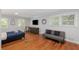 Well-lit bedroom with hardwood floors, neutral walls, and comfortable seating at 3307 Pointe Bleue Ct, Decatur, GA 30034