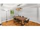 Elegant dining room with a modern chandelier, hardwood floors, and contemporary decor at 3307 Pointe Bleue Ct, Decatur, GA 30034
