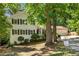 Charming two-story home with white brick, black shutters, and a two car garage at 3307 Pointe Bleue Ct, Decatur, GA 30034