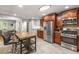 Updated kitchen showcasing stainless steel appliances, stone countertops, and a breakfast bar with seating at 3307 Pointe Bleue Ct, Decatur, GA 30034