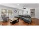 Spacious living area with hardwood floors, gray sectional sofa, dining set, and natural light at 3307 Pointe Bleue Ct, Decatur, GA 30034
