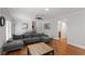 Inviting living room with hardwood floors, gray sectional sofa, and plenty of natural light at 3307 Pointe Bleue Ct, Decatur, GA 30034
