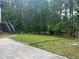 Spacious backyard featuring a storage shed, and lots of greenery, perfect for outdoor activities at 5022 Cliff Top Dr, Loganville, GA 30052