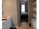 A modern bathroom featuring a white vanity and a view into the bedroom at 5022 Cliff Top Dr, Loganville, GA 30052