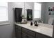 Bathroom features gray cabinets, sleek fixtures, white countertops and double windows at 5022 Cliff Top Dr, Loganville, GA 30052