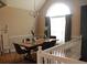 Bright dining room with a large arched window, chandelier and hardwood floors at 5022 Cliff Top Dr, Loganville, GA 30052