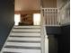 Elegant staircase with white railings and neutral tones, creating a bright and airy feel at 5022 Cliff Top Dr, Loganville, GA 30052
