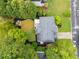 Stunning aerial view of home with lush green landscaping and mature trees surrounding the property at 6790 Wolford Ct, Johns Creek, GA 30097
