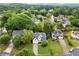 Lovely aerial view of a home in a serene, tree-lined neighborhood with well-manicured lawns at 6790 Wolford Ct, Johns Creek, GA 30097