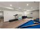 Bright basement featuring a blue pool table, gym equipment, and comfortable seating at 6790 Wolford Ct, Johns Creek, GA 30097
