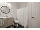 This simple bathroom features a clean vanity, large mirror, and tiled flooring at 6790 Wolford Ct, Johns Creek, GA 30097