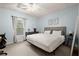 Comfortable bedroom with a soft color scheme, natural light, and plush carpeting at 6790 Wolford Ct, Johns Creek, GA 30097
