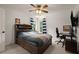 Bedroom featuring a full bed, ceiling fan, and striped curtains at 6790 Wolford Ct, Johns Creek, GA 30097