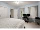 This cozy bedroom is brightly lit and features a spacious workspace at 6790 Wolford Ct, Johns Creek, GA 30097