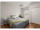 Comfortable bedroom with wood floors, a full bed, and a double door closet at 6790 Wolford Ct, Johns Creek, GA 30097