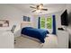 Well-lit bedroom featuring a desk, TV, and natural light at 6790 Wolford Ct, Johns Creek, GA 30097