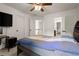 Bedroom with neutral walls, ceiling fan, and TV on the wall at 6790 Wolford Ct, Johns Creek, GA 30097