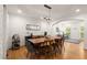 Open dining area with hardwood floors, elegant lighting and view to the living area at 6790 Wolford Ct, Johns Creek, GA 30097