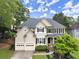 Charming two-story home featuring a two-car garage, manicured lawn, and beautiful landscaping at 6790 Wolford Ct, Johns Creek, GA 30097