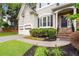 Attractive home exterior with stone accents, a two-car garage, and beautifully landscaped front yard at 6790 Wolford Ct, Johns Creek, GA 30097