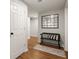 Bright hallway decorated with a chic mirror, a bench, and patterned rug at 6790 Wolford Ct, Johns Creek, GA 30097