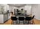 Modern kitchen featuring a large island with granite countertops and stylish black barstools at 6790 Wolford Ct, Johns Creek, GA 30097