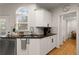 Bright kitchen with a stainless steel dishwasher, faucet, and black counter tops at 6790 Wolford Ct, Johns Creek, GA 30097