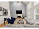 Bright living room featuring vaulted ceilings, hardwood floors, fireplace, and plantation shutters on the large windows at 6790 Wolford Ct, Johns Creek, GA 30097