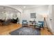 Stylish living room with open access to dining area featuring hardwood floors and natural light at 6790 Wolford Ct, Johns Creek, GA 30097