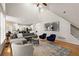 Open-concept living room with hardwood floors and direct access to a modern kitchen and dining area at 6790 Wolford Ct, Johns Creek, GA 30097