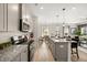 Modern kitchen featuring granite countertops, stainless steel appliances, and a view to the living room at 12 Jacobs Farm Ln # 6, Lawrenceville, GA 30045