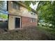 The backyard shows the home's siding and brick exterior, a door, and a small grass yard at 1247 Shoreham Dr, Atlanta, GA 30349